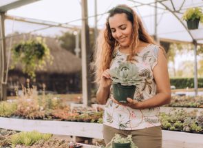 smiling-woman-business-owner-holding-succulent-pla-38L2FQK.jpg